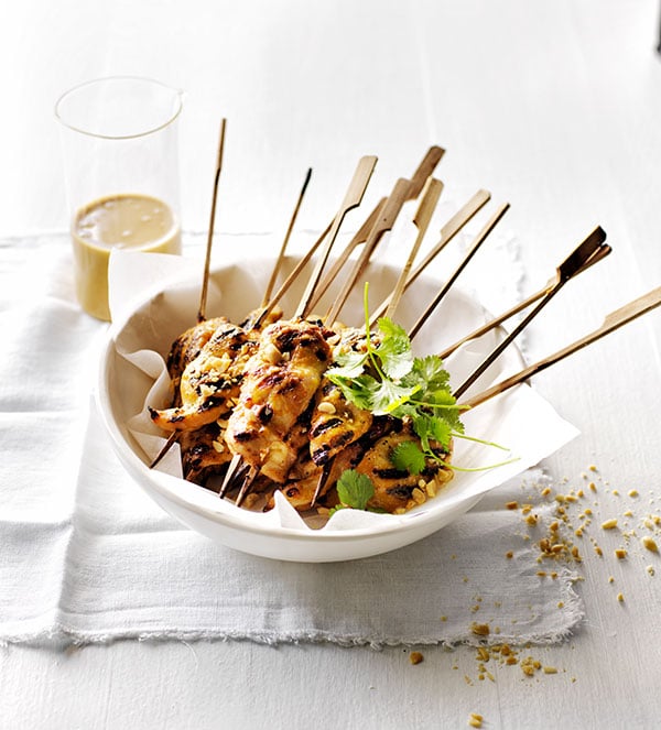 Chicken satay skewers in a bowl